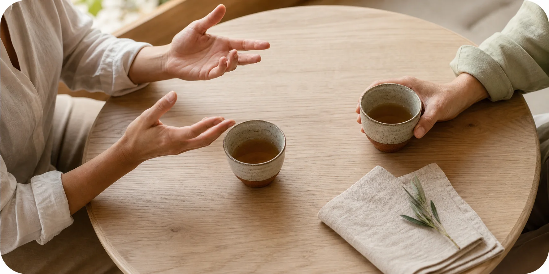 Two people sharing tea during a relaxed conversation